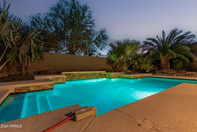 view of pool at dusk