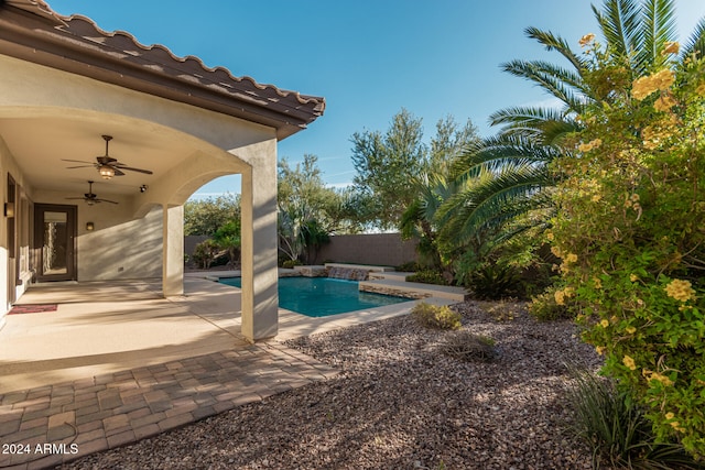 view of pool with ceiling fan and a patio area