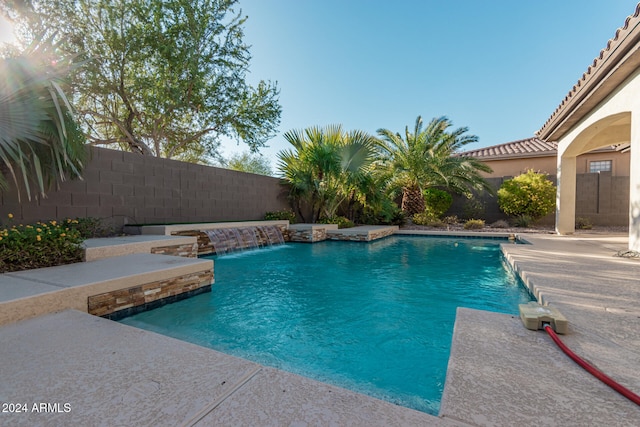 view of swimming pool with pool water feature