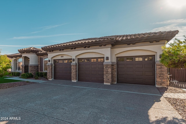 mediterranean / spanish-style home with a garage