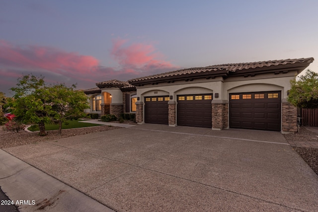 mediterranean / spanish-style home featuring a garage