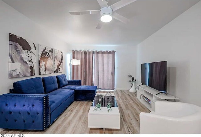 living room with ceiling fan and light hardwood / wood-style flooring