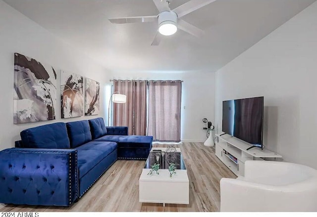 living area with light wood finished floors and ceiling fan