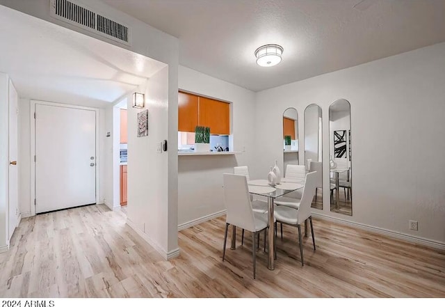 dining area with light wood-type flooring