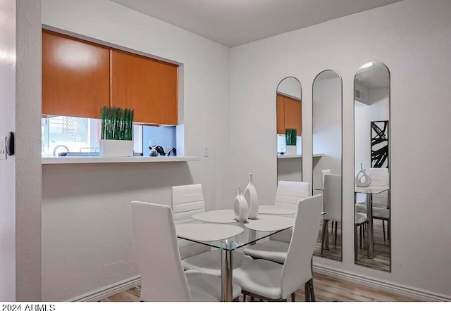 dining space with light hardwood / wood-style flooring