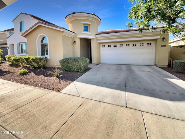 21081 W Almeria Rd, Buckeye, AZ 85396 - mediterranean / spanish home featuring stucco siding, a tile roof, an attached garage, and concrete driveway