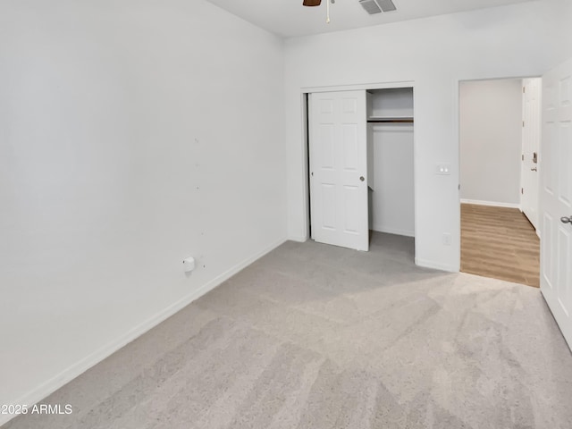 21081 W Almeria Rd, Buckeye, AZ 85396 - unfurnished bedroom featuring baseboards, carpet floors, ceiling fan, and a closet