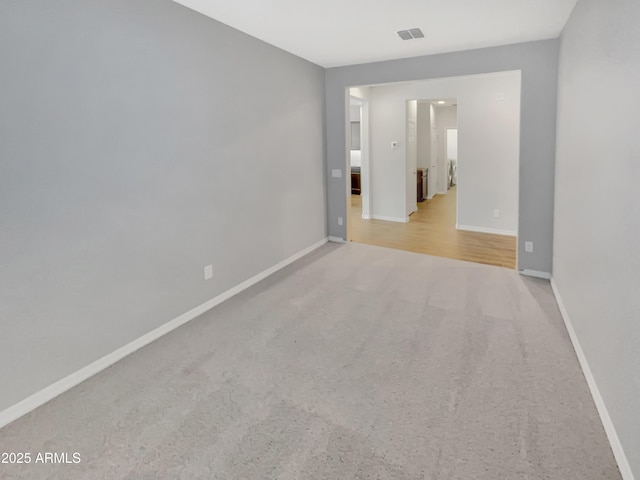21081 W Almeria Rd, Buckeye, AZ 85396 - unfurnished room with baseboards, visible vents, and carpet