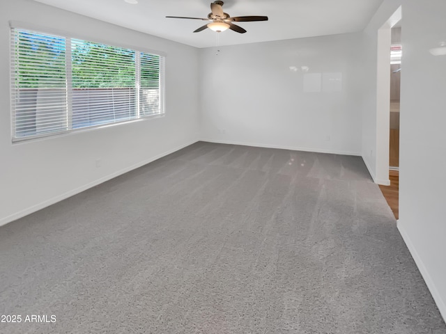 21081 W Almeria Rd, Buckeye, AZ 85396 - unfurnished room with carpet floors, baseboards, and ceiling fan