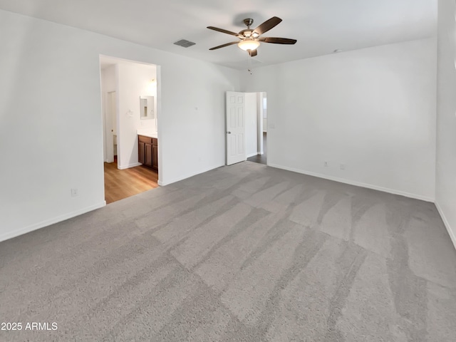 21081 W Almeria Rd, Buckeye, AZ 85396 - unfurnished bedroom with ensuite bathroom, ceiling fan, carpet, baseboards, and visible vents