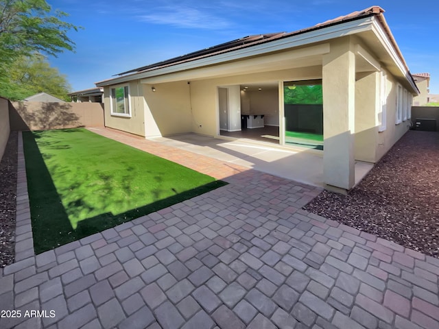 21081 W Almeria Rd, Buckeye, AZ 85396 - back of house featuring a patio, a fenced backyard, and stucco siding