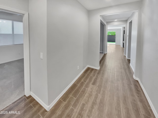 21081 W Almeria Rd, Buckeye, AZ 85396 - hallway with baseboards and wood finished floors