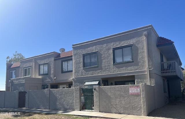 2311 E Hartford Ave Unit 38, Phoenix, AZ 85022 - view of front of house with a gate, a fenced front yard, stucco siding, and a tiled roof