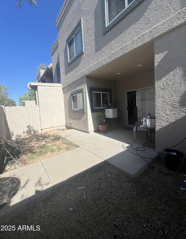 2311 E Hartford Ave Unit 38, Phoenix, AZ 85022 - rear view of house featuring stucco siding and a patio