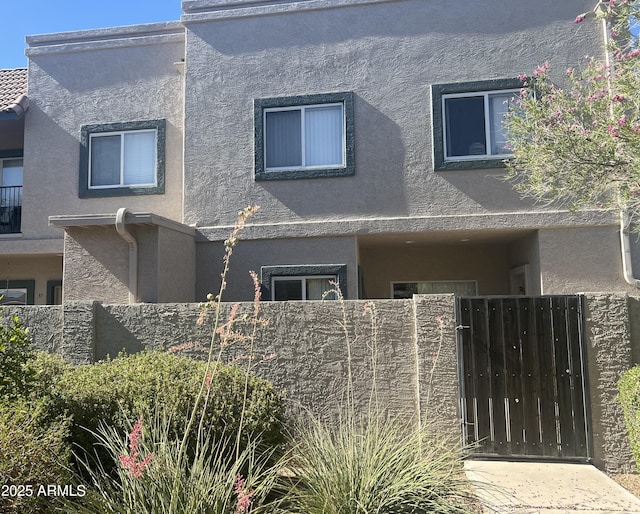2311 E Hartford Ave Unit 38, Phoenix, AZ 85022 - view of front facade featuring stucco siding and a gate