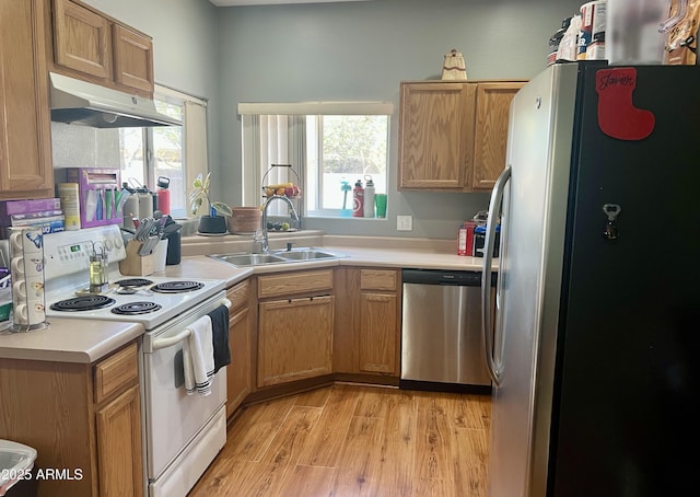 2311 E Hartford Ave Unit 38, Phoenix, AZ 85022 - kitchen with stainless steel appliances, under cabinet range hood, light countertops, and light wood-style flooring