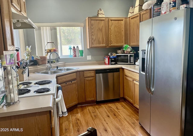 2311 E Hartford Ave Unit 38, Phoenix, AZ 85022 - kitchen featuring appliances with stainless steel finishes, light wood-style floors, light countertops, and exhaust hood