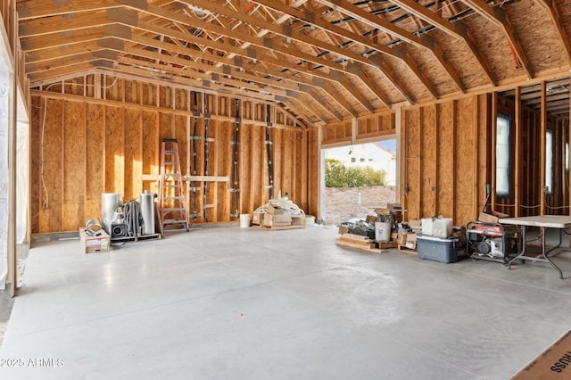 miscellaneous room featuring lofted ceiling and concrete flooring