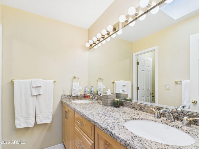 full bathroom with double vanity and a sink