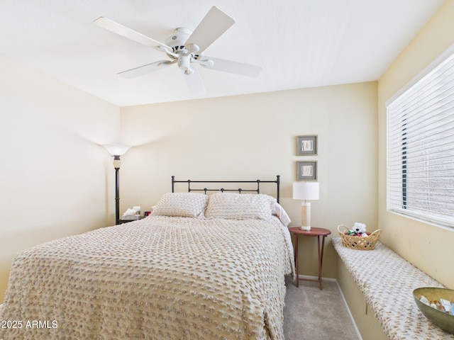 bedroom featuring light carpet, baseboards, and ceiling fan