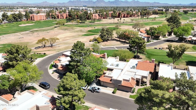 drone / aerial view featuring a mountain view, view of golf course, and a residential view
