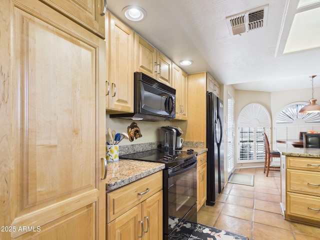 kitchen with visible vents, black appliances, light brown cabinetry, and light stone counters