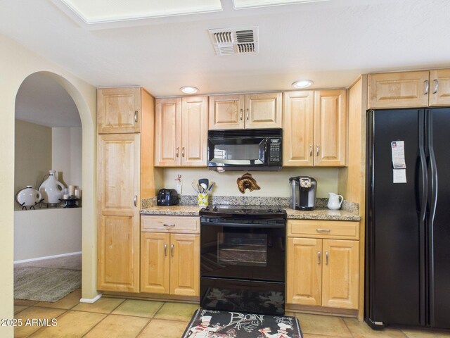 kitchen with light tile patterned floors, visible vents, arched walkways, black appliances, and light brown cabinetry