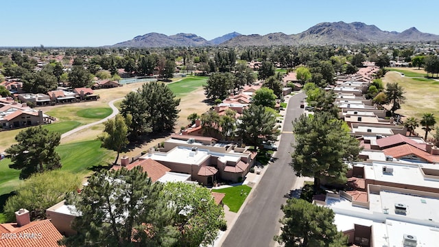 drone / aerial view with golf course view, a mountain view, and a residential view