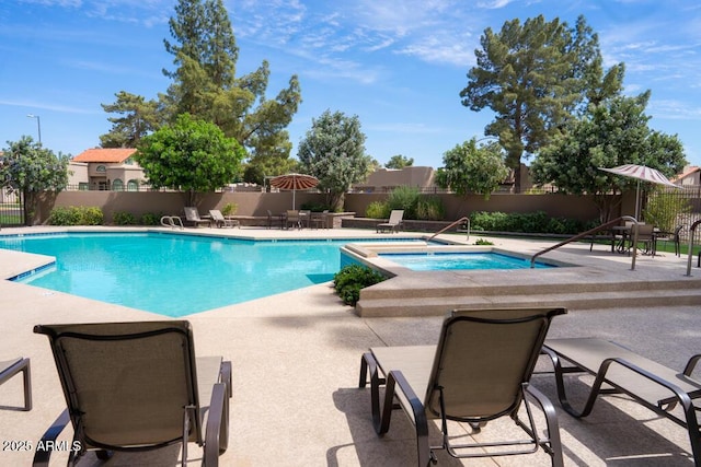 community pool with a community hot tub, fence, and a patio