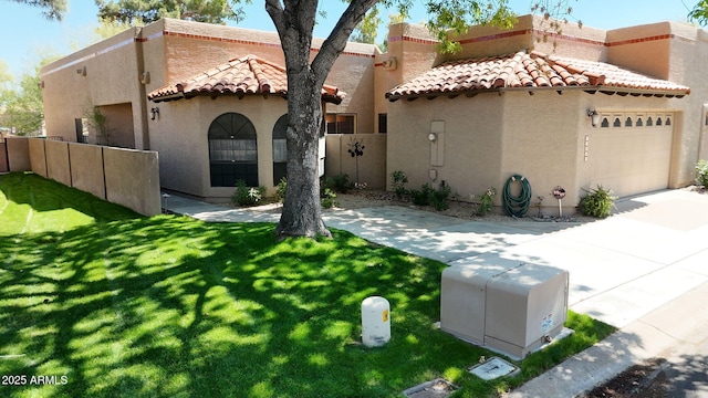 mediterranean / spanish home with stucco siding, a garage, a tiled roof, and fence