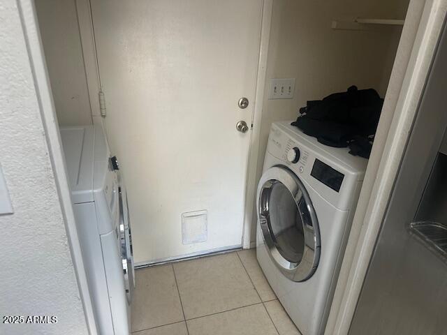 laundry room with laundry area and light tile patterned floors