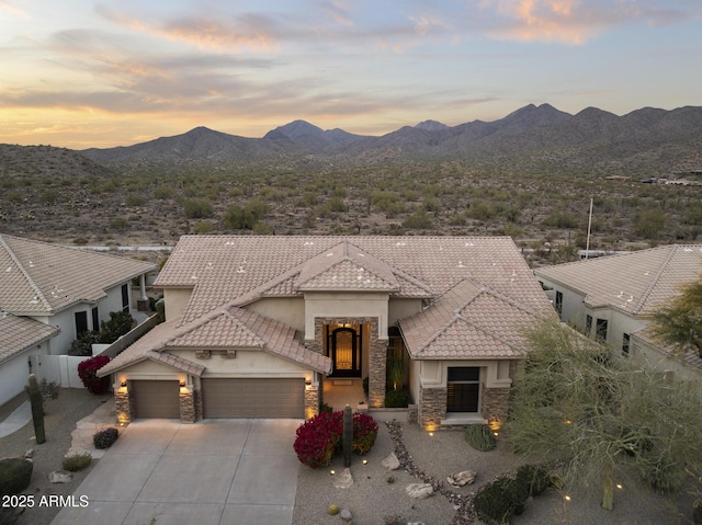 view of front facade featuring a garage and a mountain view