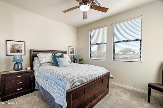 bedroom with light carpet, ceiling fan, and baseboards