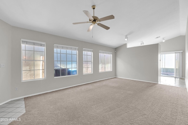 carpeted spare room with ceiling fan, a wealth of natural light, and lofted ceiling