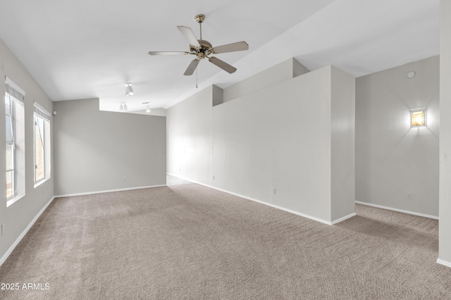 spare room with ceiling fan and light colored carpet