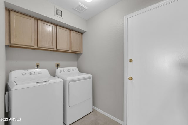 laundry room featuring cabinets and washing machine and dryer