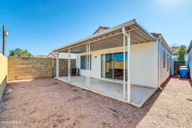 rear view of property featuring a patio area and central air condition unit