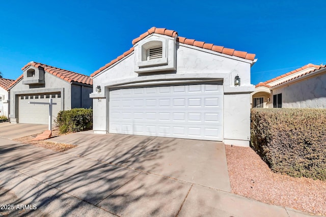 mediterranean / spanish-style home with a garage