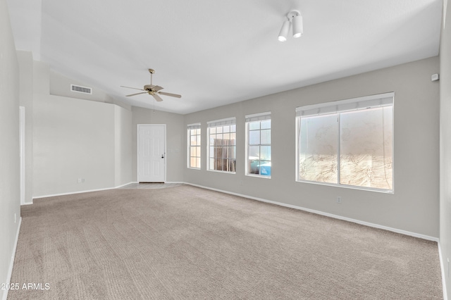 carpeted spare room with ceiling fan and vaulted ceiling