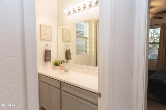 bathroom featuring ceiling fan and vanity