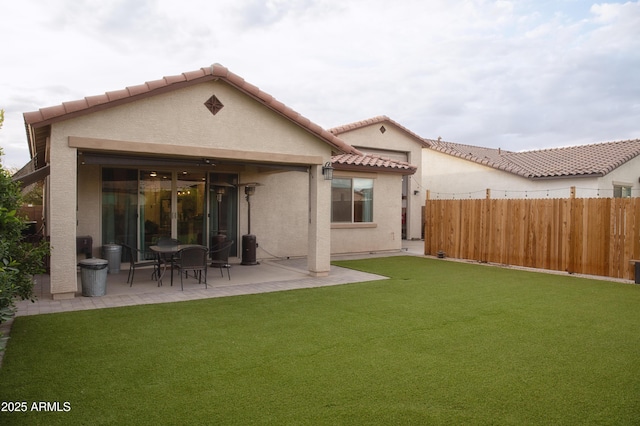 back of property featuring a yard and a patio