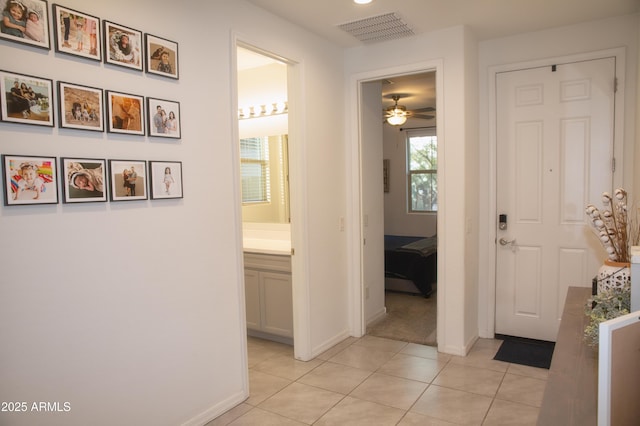 hall featuring light tile patterned floors