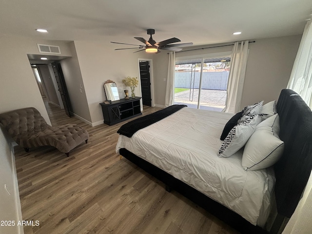 bedroom featuring visible vents, ceiling fan, wood finished floors, access to outside, and baseboards