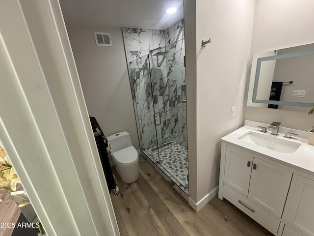 full bathroom with visible vents, toilet, a marble finish shower, and wood finished floors