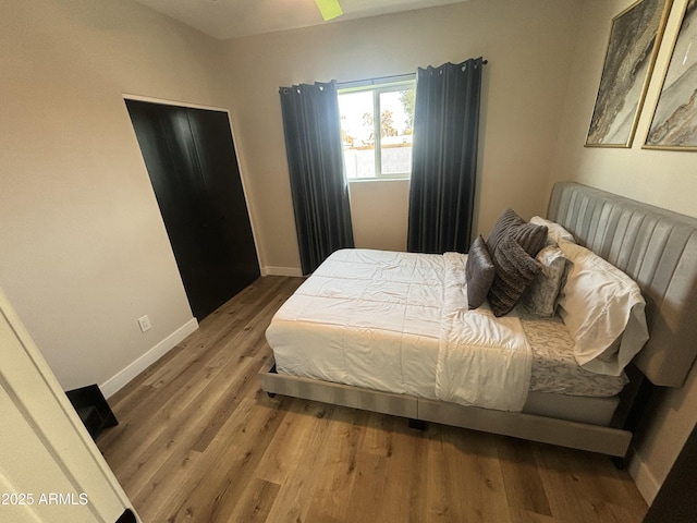 bedroom with wood finished floors and baseboards