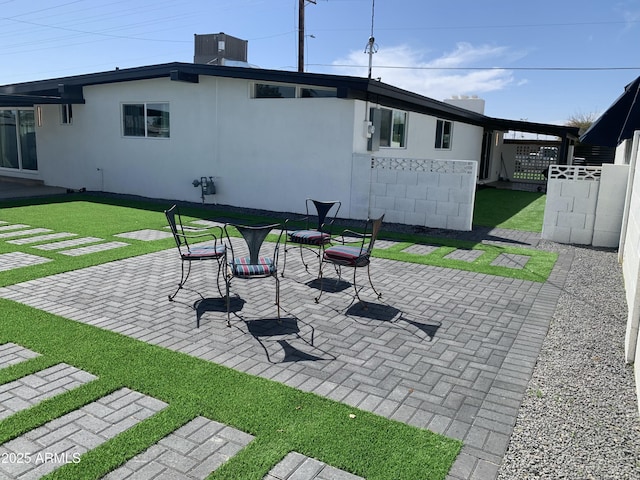 view of patio featuring cooling unit and fence