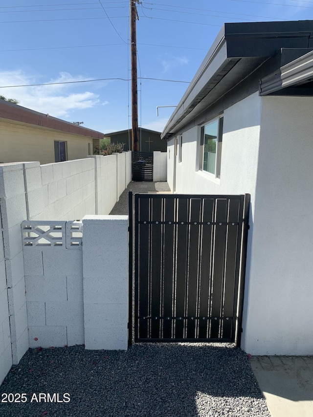 view of gate featuring a fenced backyard