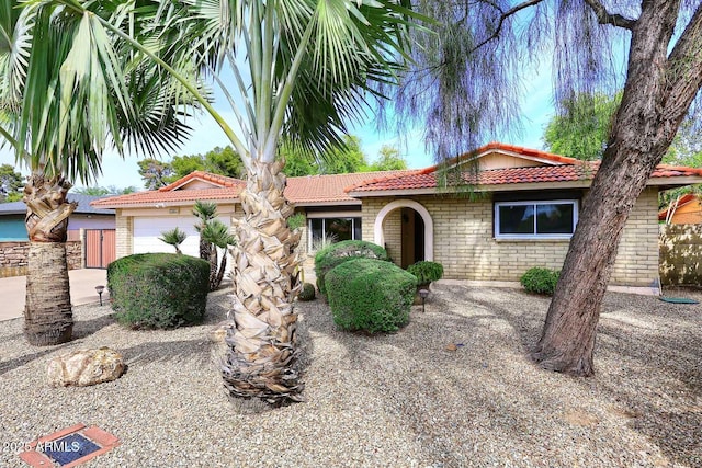 7521 S College Ave, Tempe, AZ 85283 - ranch-style house featuring an attached garage, a tile roof, and brick siding