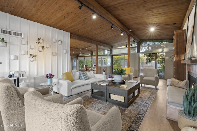 1522 W Myrtle Ave, Phoenix, AZ 85021 - living area featuring track lighting, wood ceiling, hardwood / wood-style flooring, and a lit fireplace