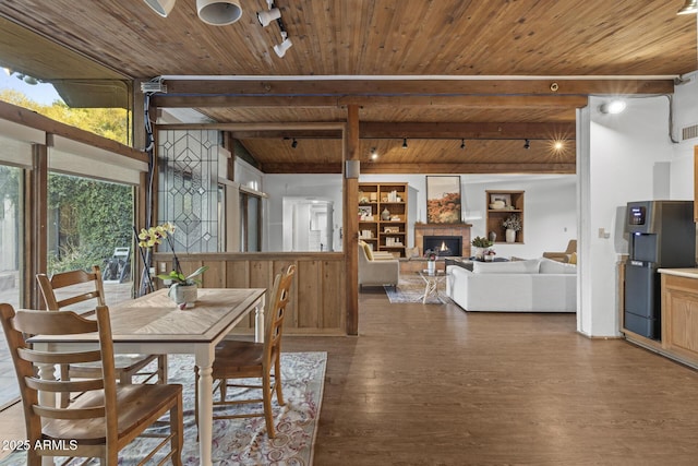 1522 W Myrtle Ave, Phoenix, AZ 85021 - dining room featuring a wood ceiling with exposed beams, wood finished floors, a warm lit fireplace, and rail lighting